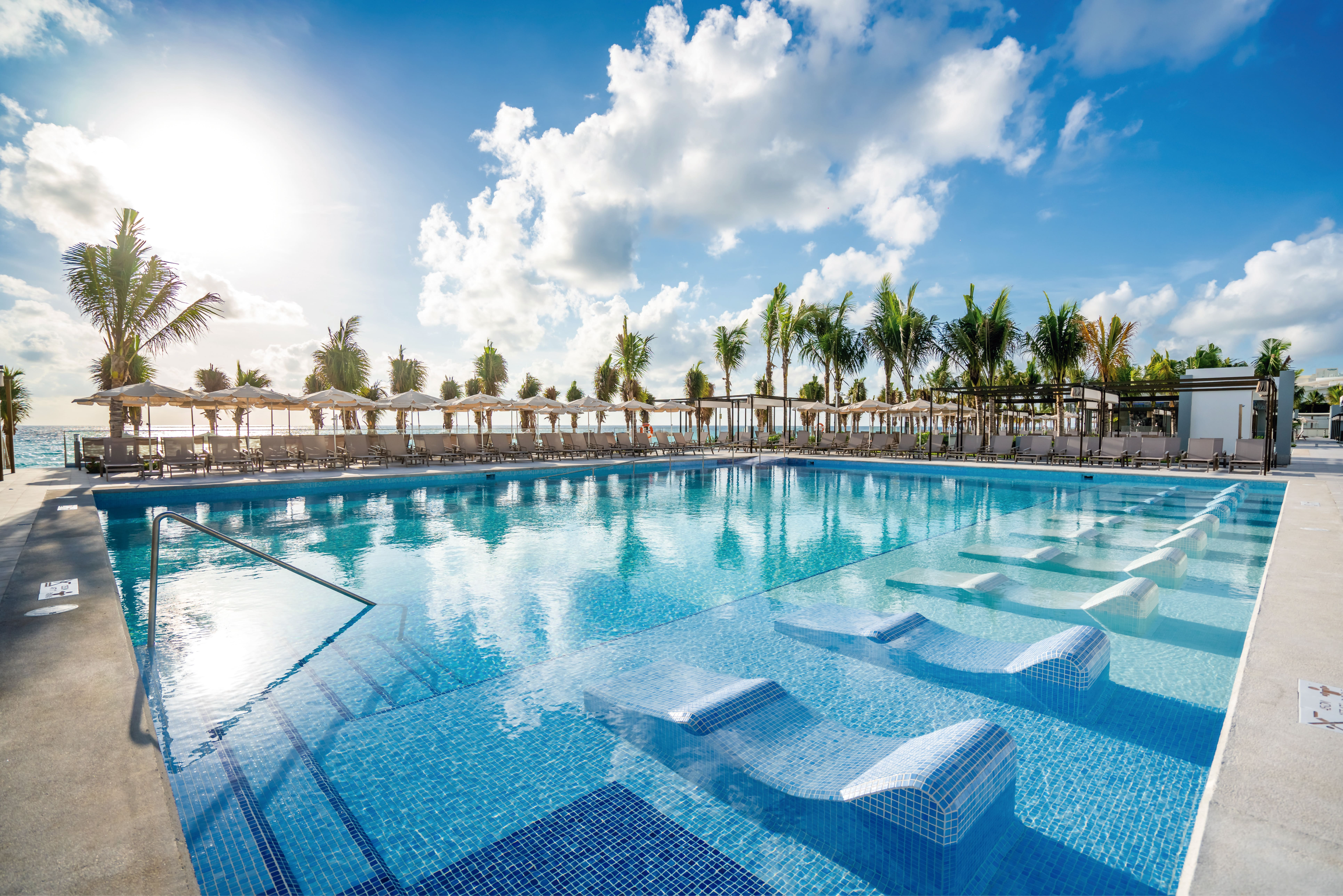 Riu Palace Kukulkan Cancun Hotel Zone Mexico Kukulkan Boulevard pool with palm trees and sea views
